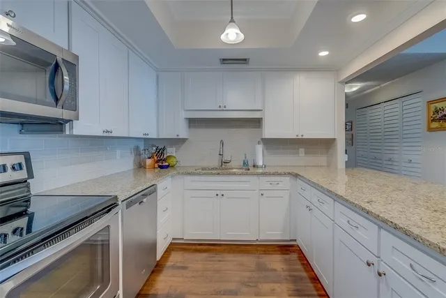 a kitchen with sink and cabinets