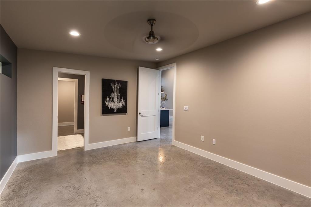 1142 Eleanor Street, Unit 2 Austin, TX 78721 - Photo 11 of 24 Recessed lighting illuminates this versatile space, featuring a ceiling fan for comfort.