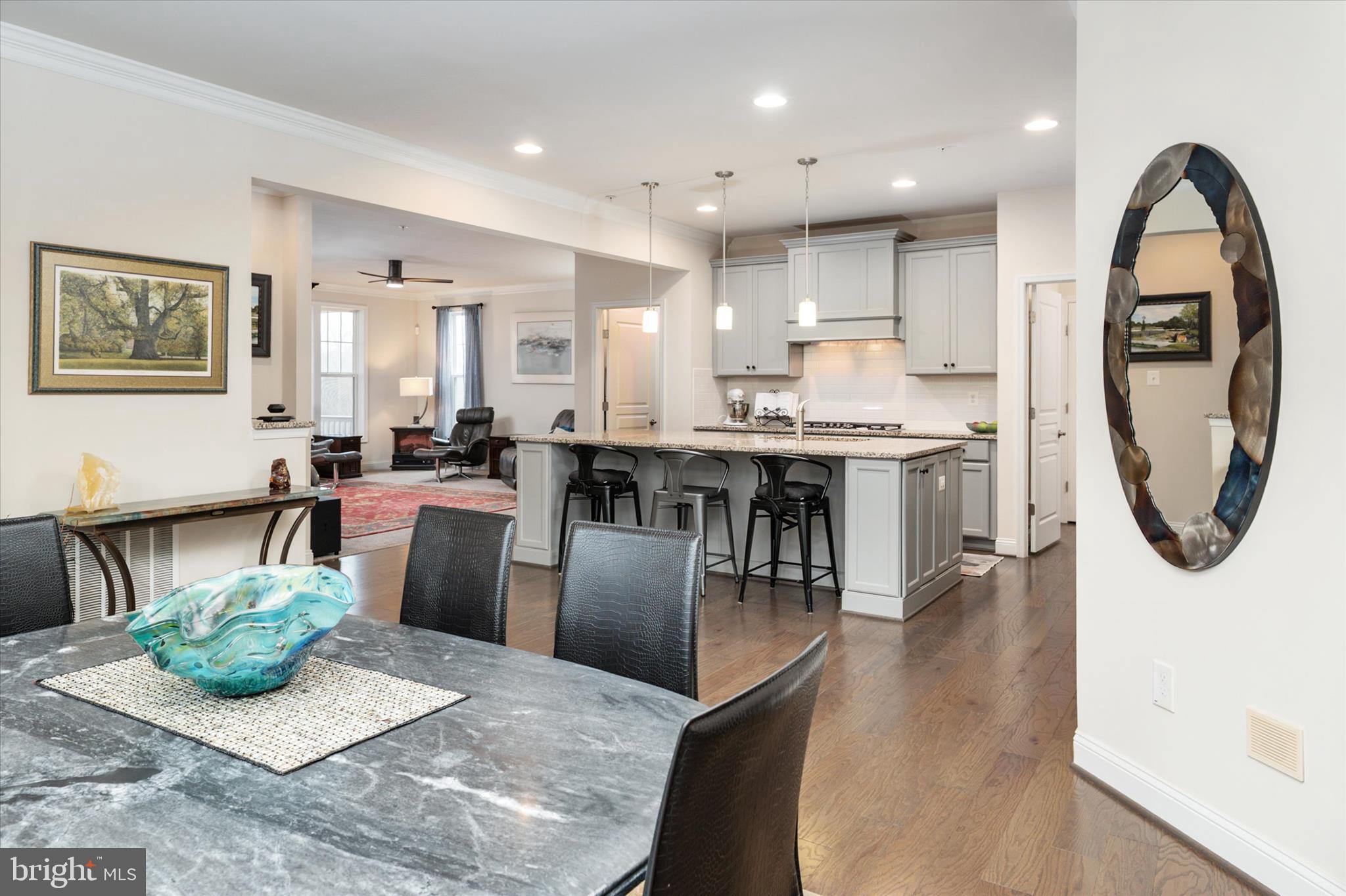 2705 Dragon Fly Way Odenton, MD 21113 - Photo 16 of 79 a kitchen with stainless steel appliances granite countertop a stove top oven a sink a dining table and chairs
