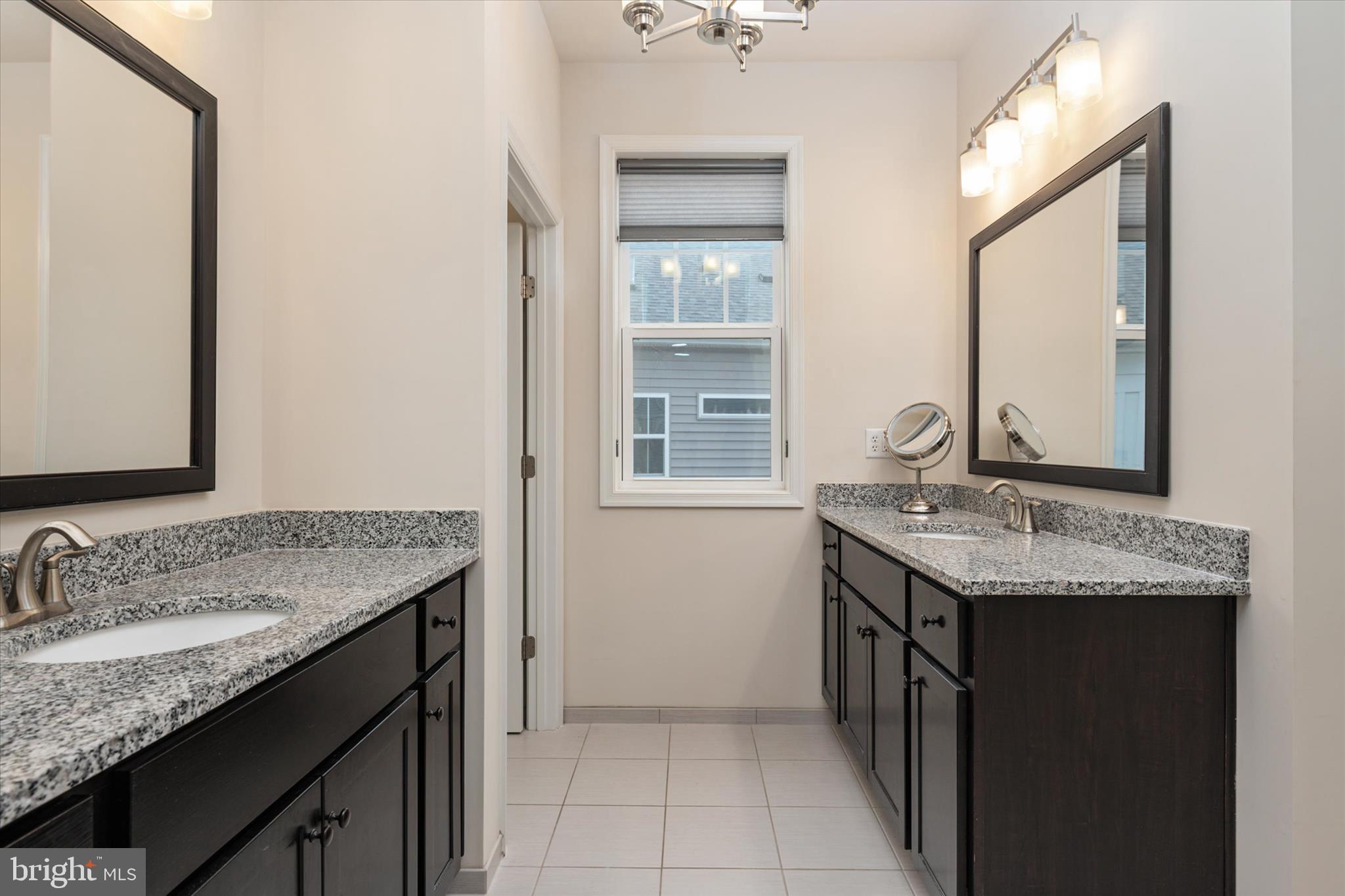 2705 Dragon Fly Way Odenton, MD 21113 - Photo 27 of 79 a bathroom with a granite countertop sink and a mirror