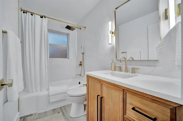 a kitchen with a table chairs refrigerator and cabinets