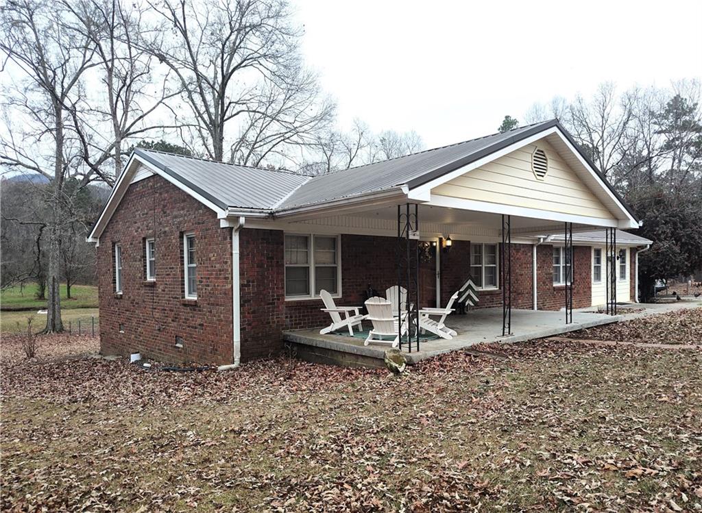 1340 Hyden Tyler Road Chatsworth, GA 30705 - Photo 43 of 65 a front view of a house with outdoor seating
