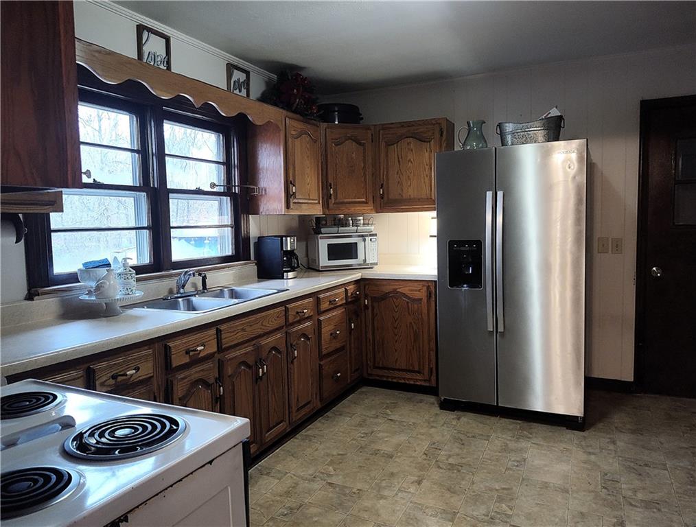 1340 Hyden Tyler Road Chatsworth, GA 30705 - Photo 50 of 65 a kitchen with stainless steel appliances granite countertop a refrigerator a sink a stove and a refrigerator