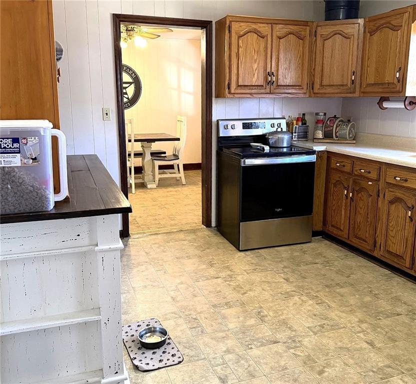 1340 Hyden Tyler Road Chatsworth, GA 30705 - Photo 51 of 65 a kitchen with stainless steel appliances granite countertop a stove a sink and a microwave
