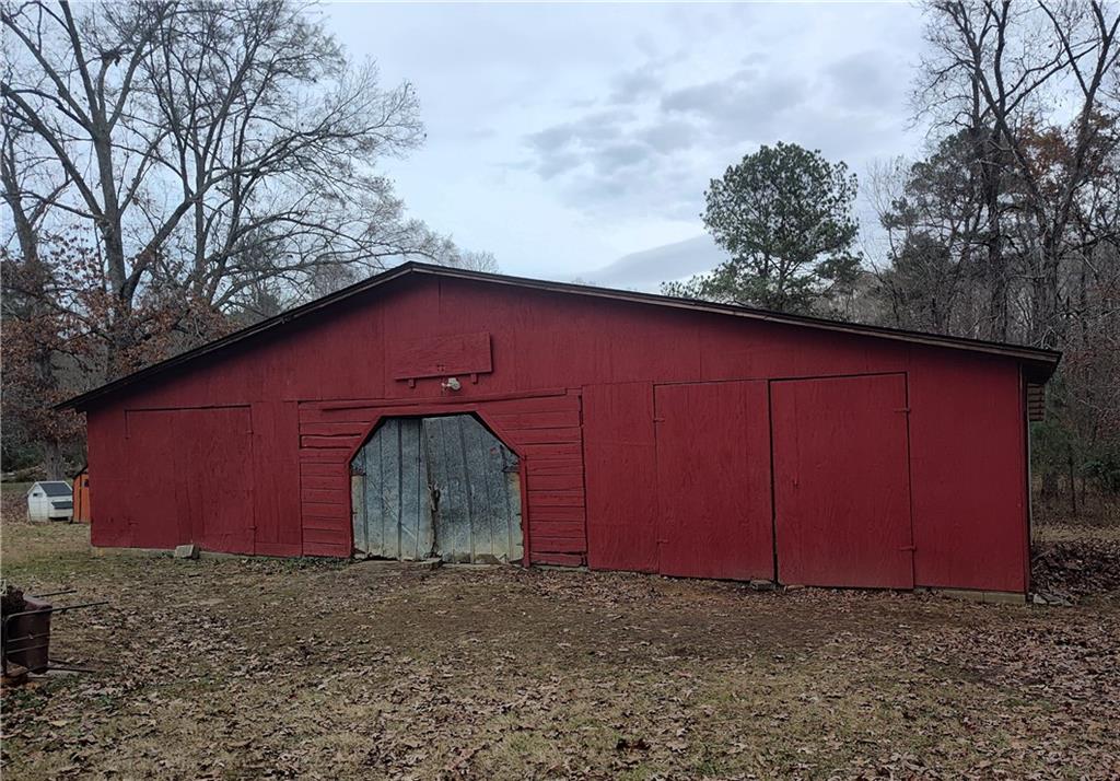 1340 Hyden Tyler Road Chatsworth, GA 30705 - Photo 58 of 65 a view of a small barn in front of a house