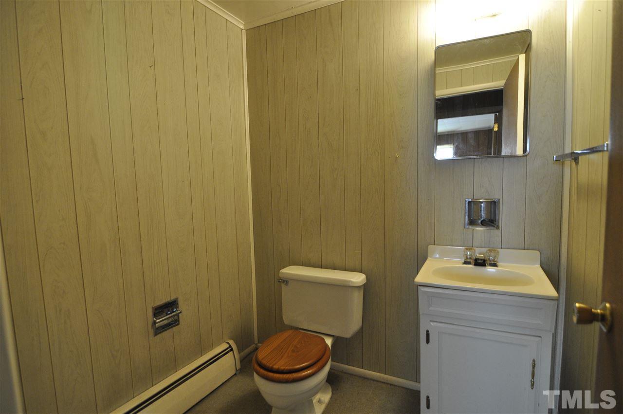 532 Princeton Street Raleigh, NC 27609 - Photo 12 of 19 a bathroom with a toilet a sink and mirror
