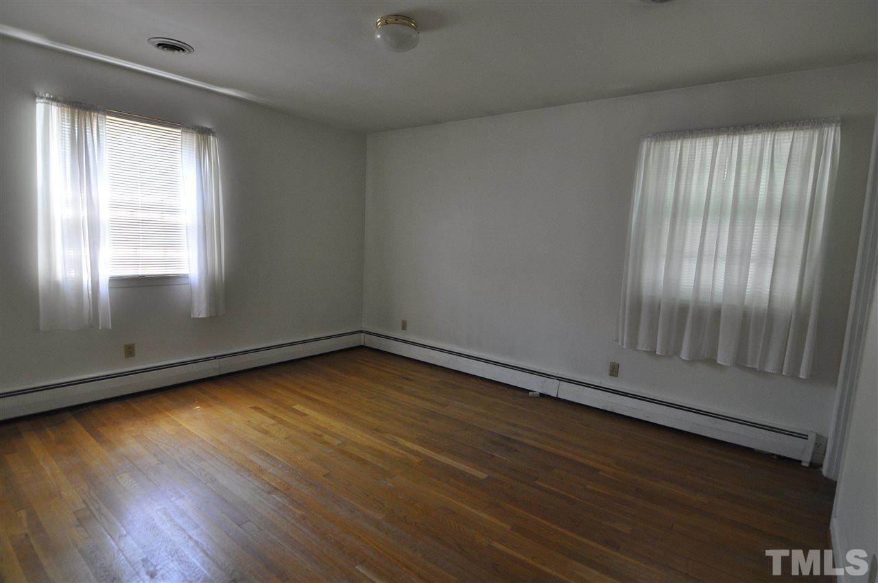 532 Princeton Street Raleigh, NC 27609 - Photo 14 of 19 an empty room with wooden floor and windows