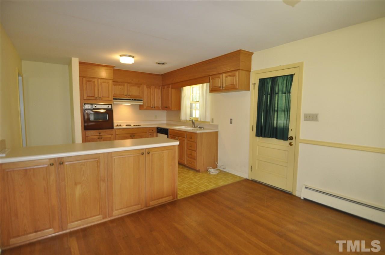 532 Princeton Street Raleigh, NC 27609 - Photo 8 of 19 a kitchen with a refrigerator and a stove top oven