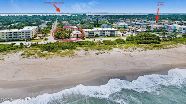 an aerial view of a swimming pool with a yard
