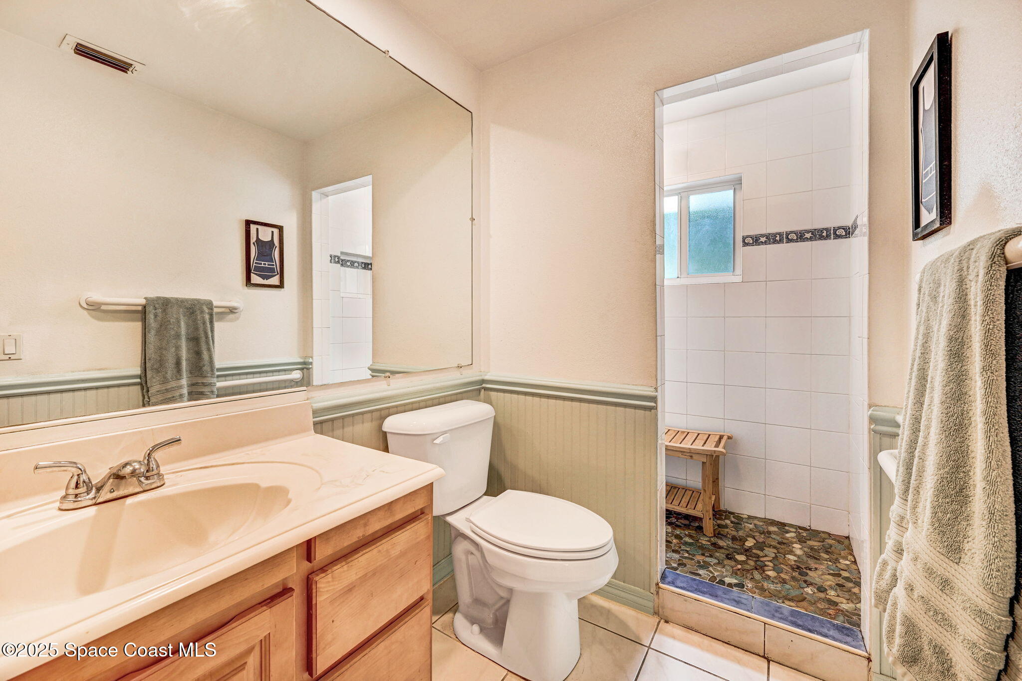 312 Wave Crest Avenue Indialantic, FL 32903 - Photo 11 of 62 a bathroom with a sink a toilet and shower