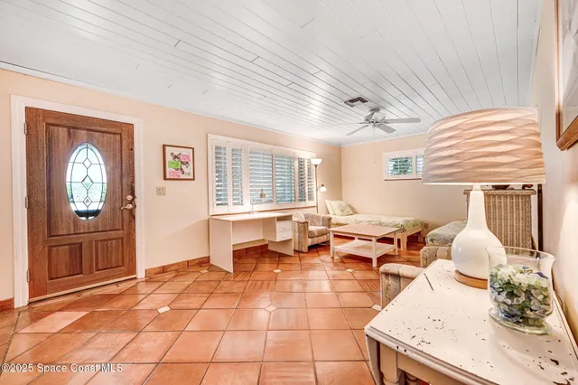 a living room with kitchen island furniture and a flat screen tv