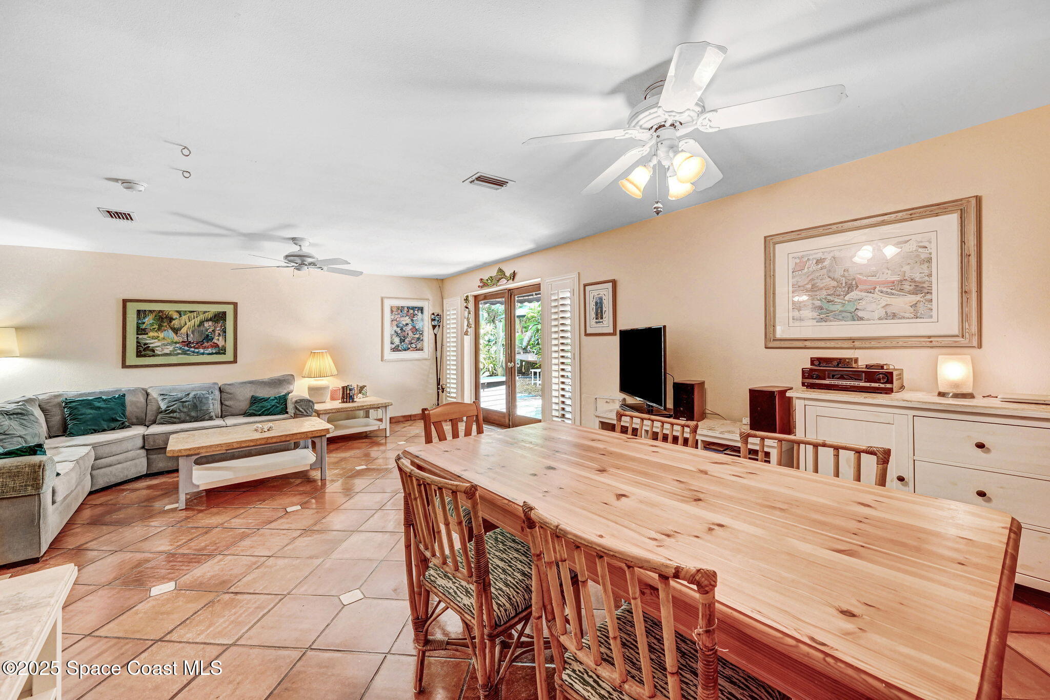 312 Wave Crest Avenue Indialantic, FL 32903 - Photo 16 of 62 a living room with kitchen island furniture and a flat screen tv