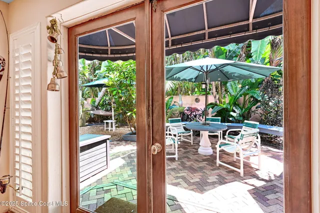 a view of a patio with table and chairs potted plants with wooden fence