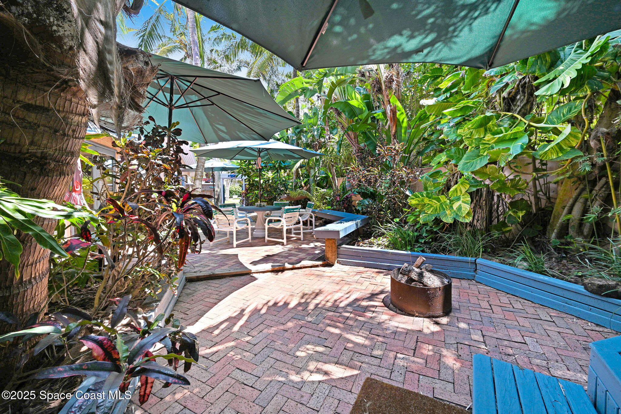312 Wave Crest Avenue Indialantic, FL 32903 - Photo 20 of 62 a view of a patio with table and chairs potted plants with wooden fence