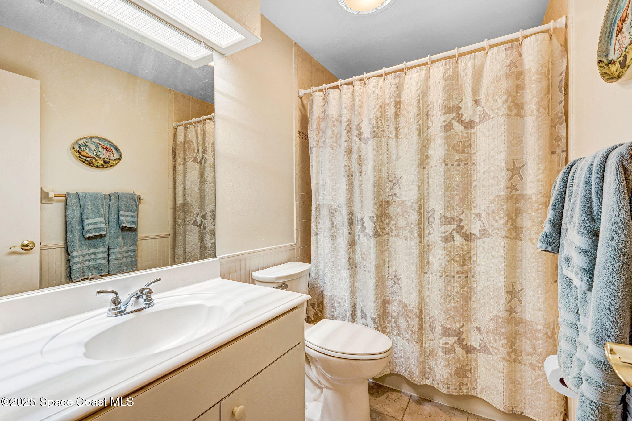 312 Wave Crest Avenue Indialantic, FL 32903 - Photo 31 of 62 a bathroom with a granite countertop sink and a mirror