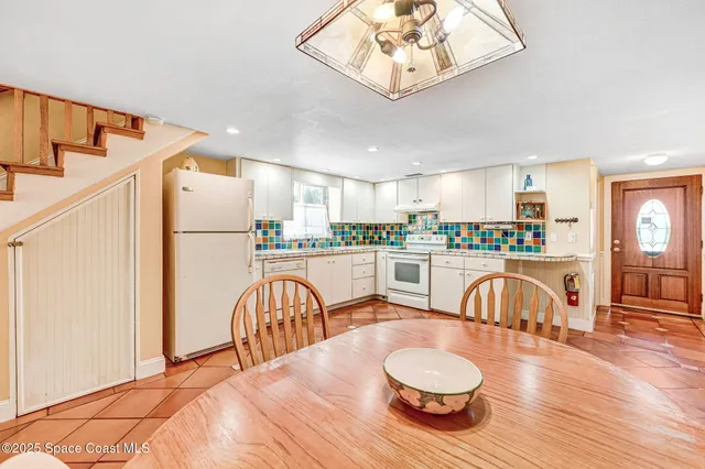 a bedroom with two beds and a chandelier