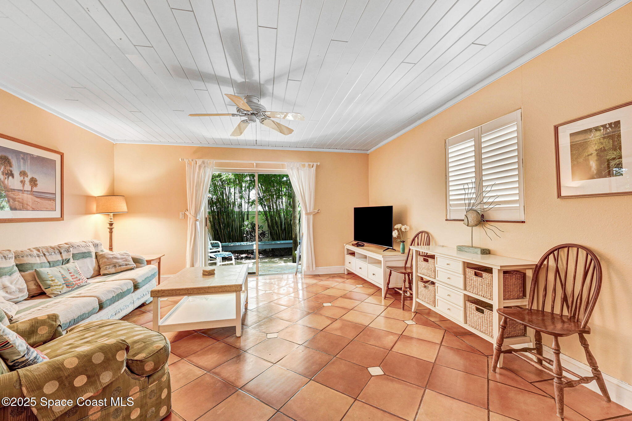 312 Wave Crest Avenue Indialantic, FL 32903 - Photo 40 of 62 a living room with furniture and a flat screen tv