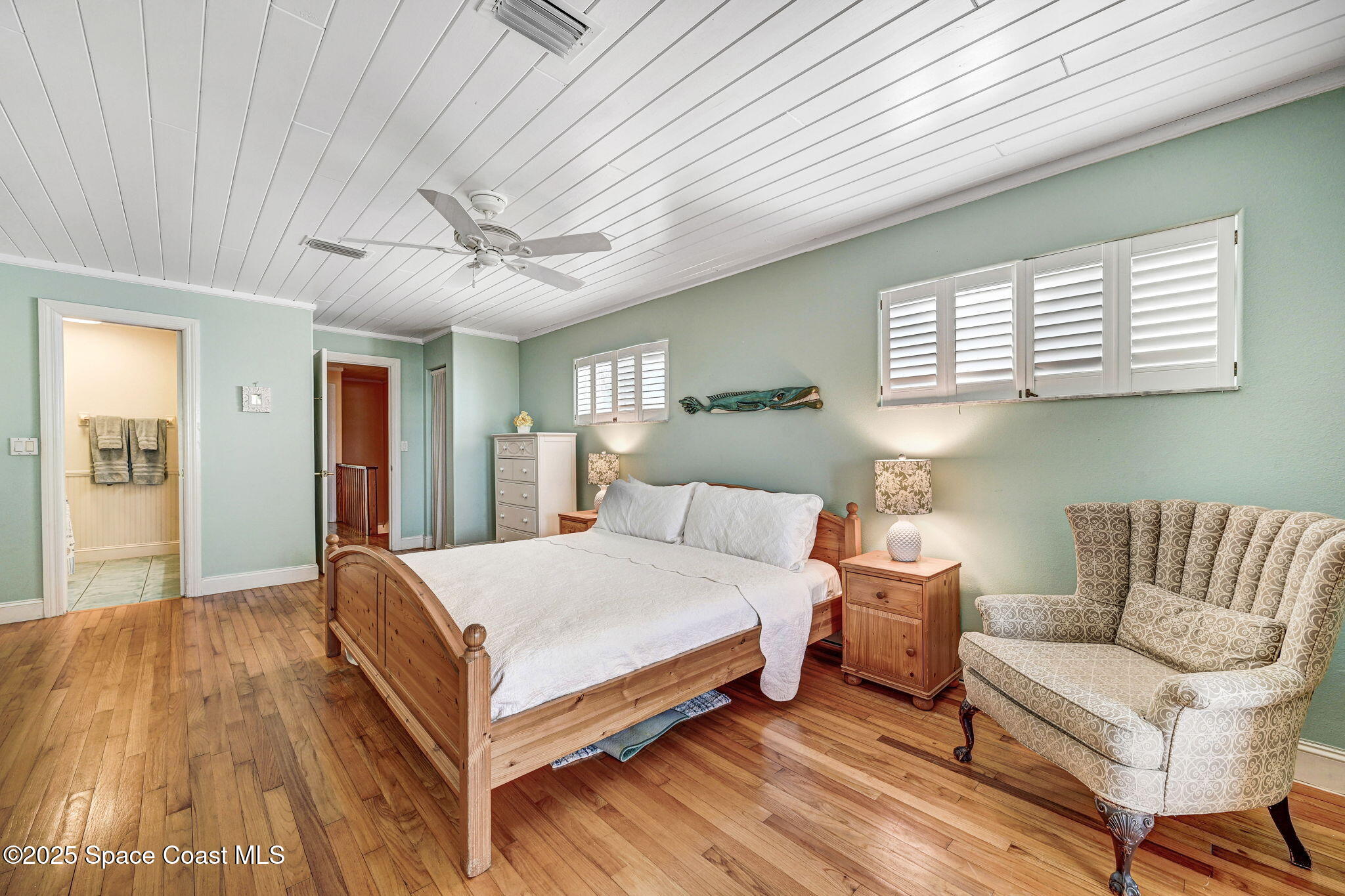 312 Wave Crest Avenue Indialantic, FL 32903 - Photo 45 of 62 a bedroom with a bed couch and window