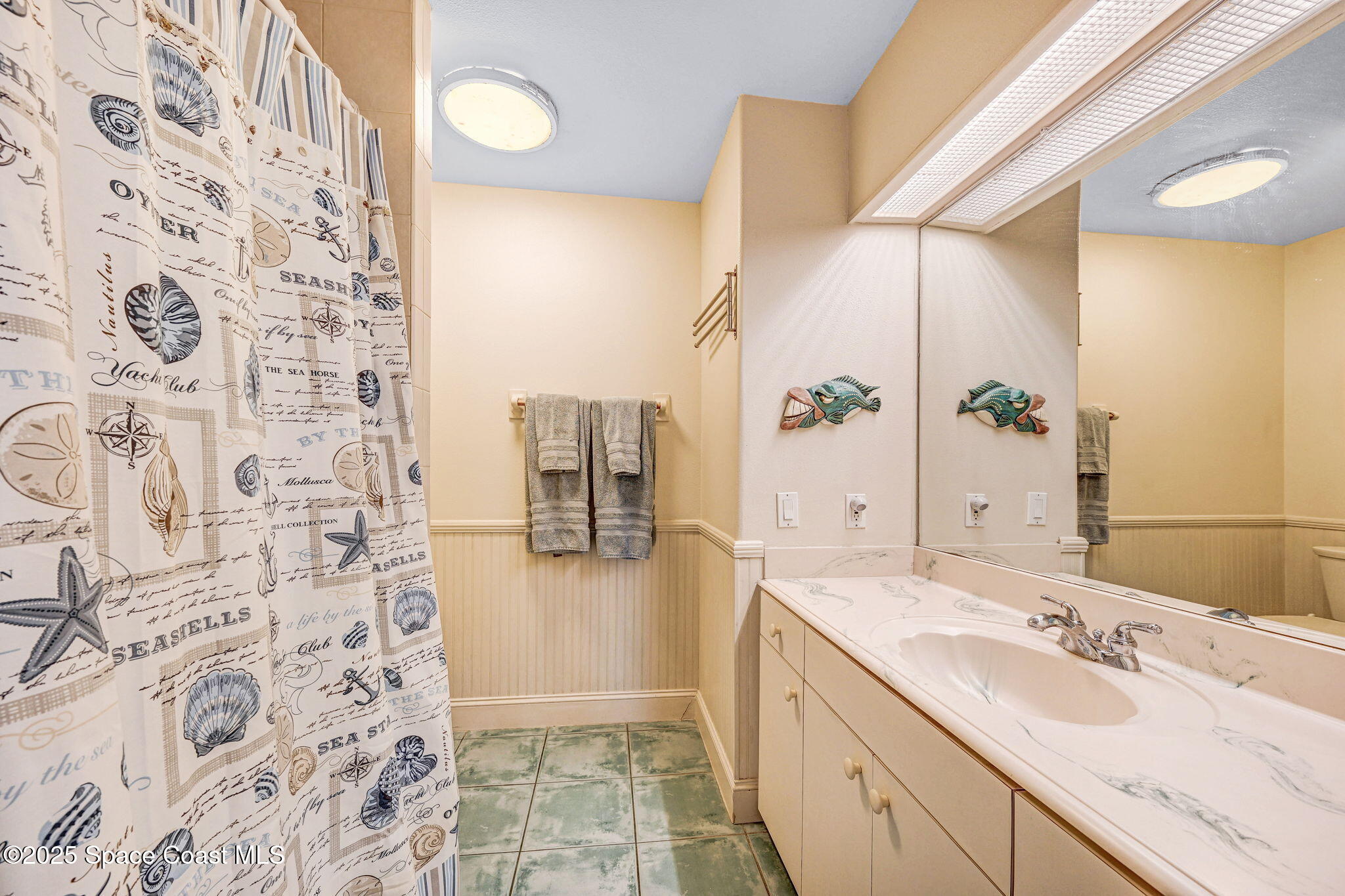 312 Wave Crest Avenue Indialantic, FL 32903 - Photo 46 of 62 a spacious bathroom with a sink and a mirror