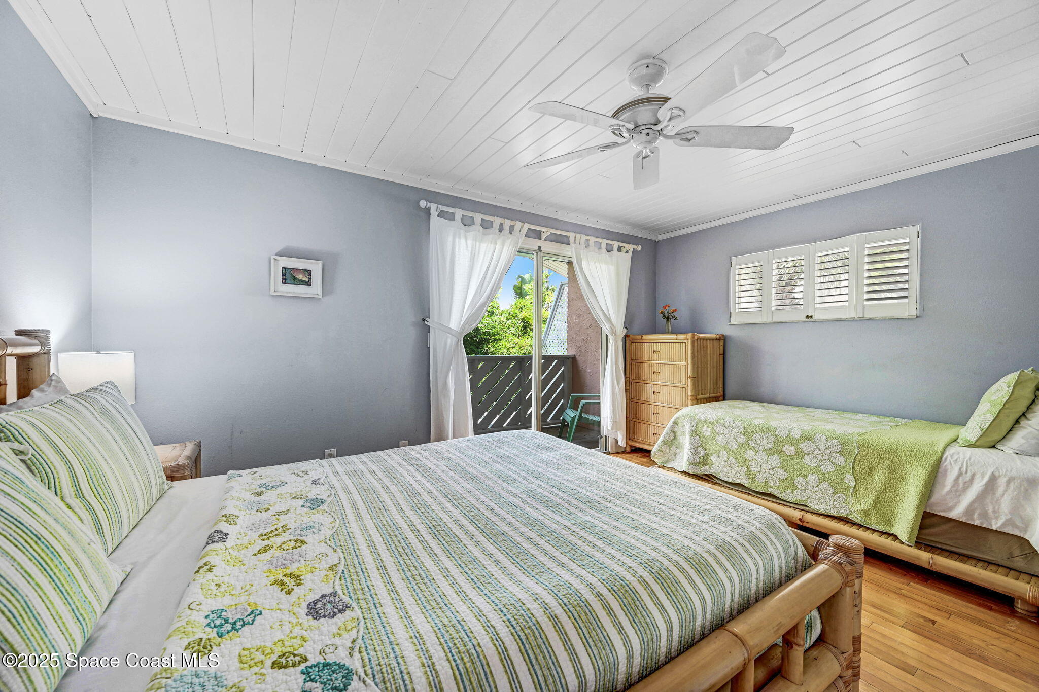 312 Wave Crest Avenue Indialantic, FL 32903 - Photo 47 of 62 a bedroom with two beds and a chandelier