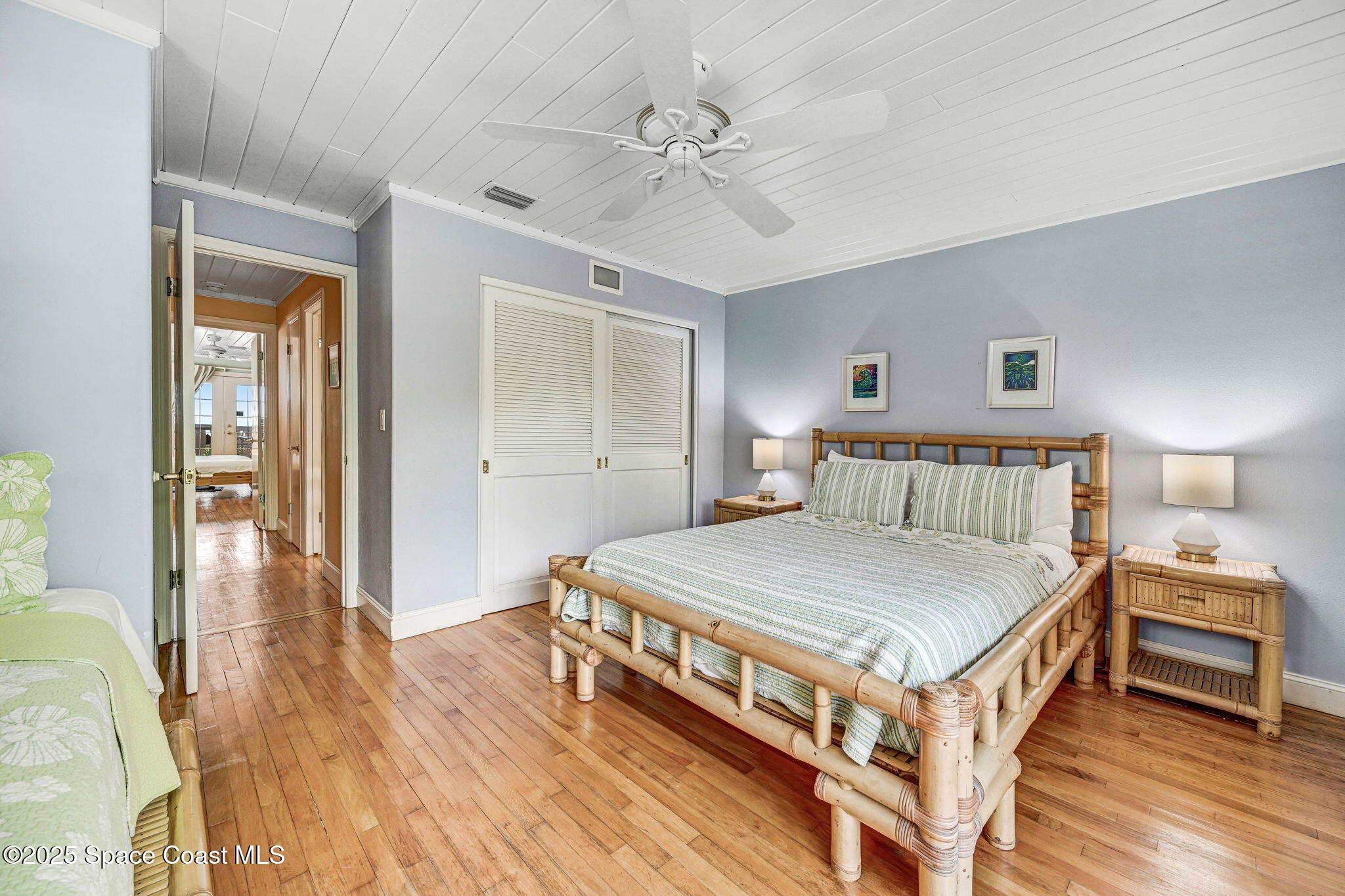 312 Wave Crest Avenue Indialantic, FL 32903 - Photo 48 of 62 a bedroom with a bed and a table with closet