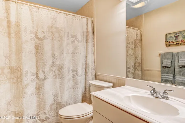 a picture of a bathroom with mirror