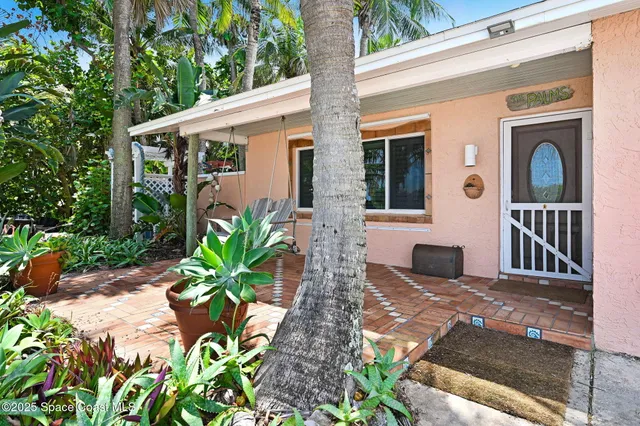a kitchen with a sink a stove a refrigerator and white cabinets