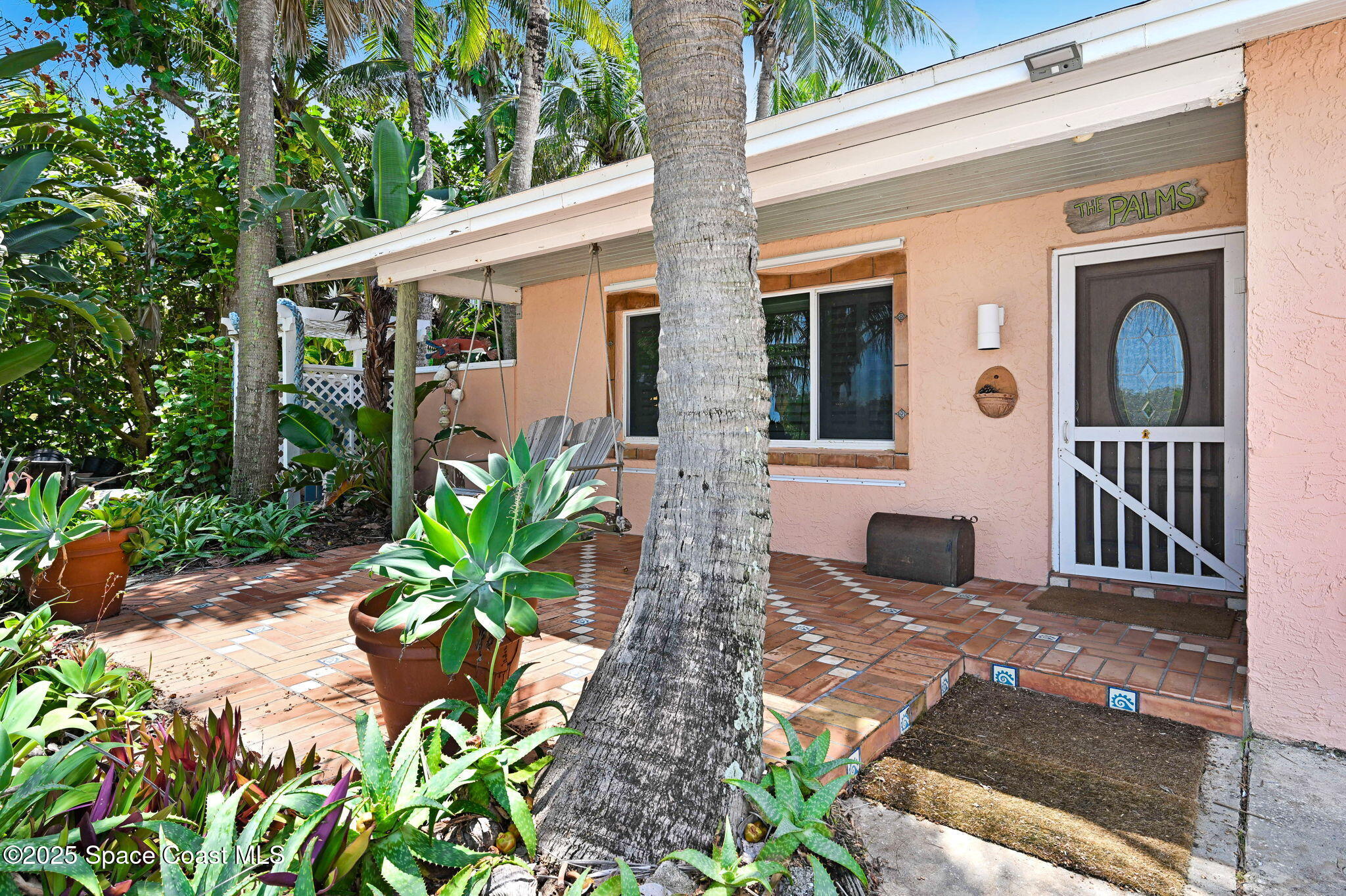 312 Wave Crest Avenue Indialantic, FL 32903 - Photo 5 of 62 a front view of a house with garden