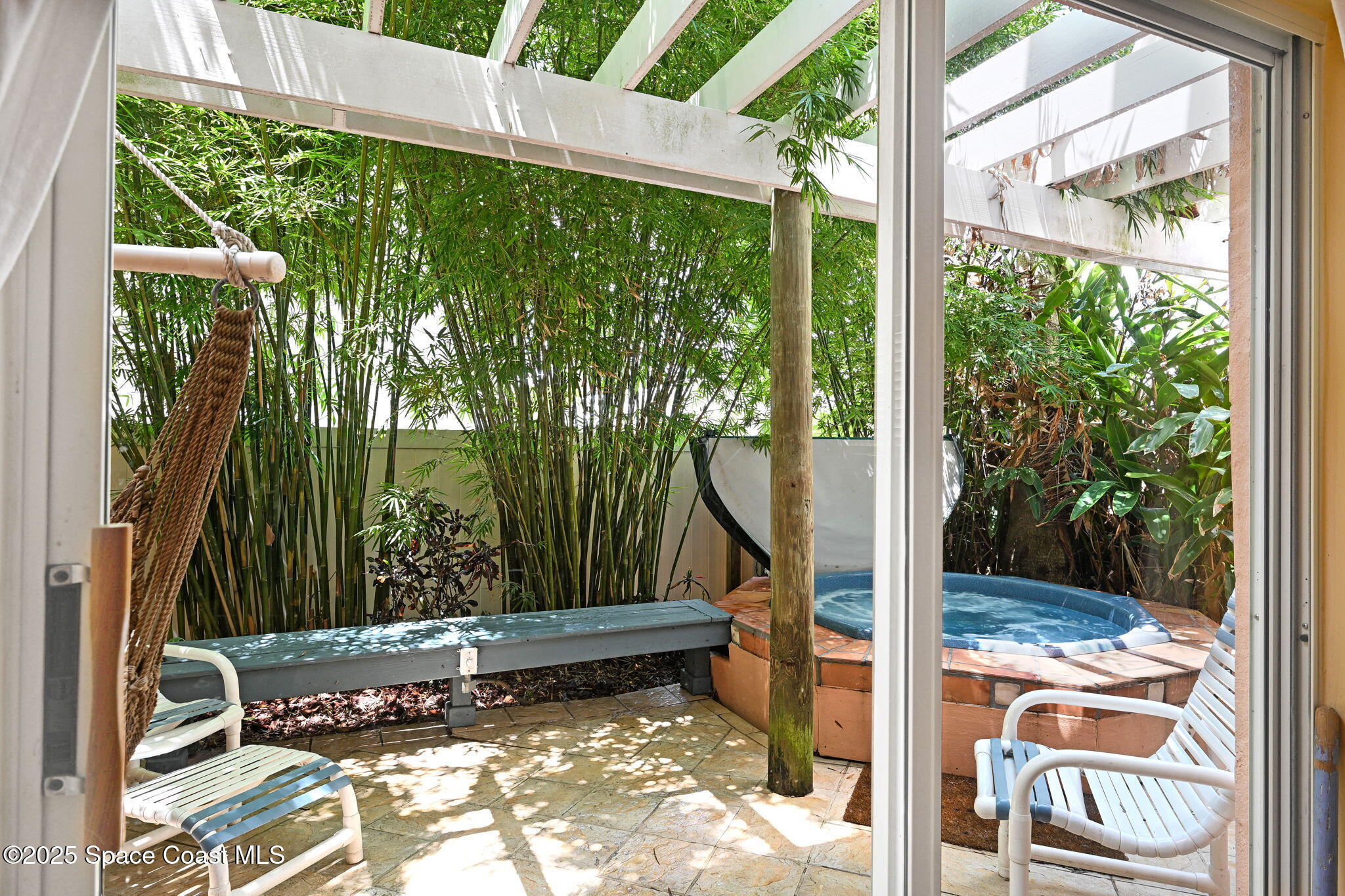 312 Wave Crest Avenue Indialantic, FL 32903 - Photo 52 of 62 a view of a porch with a floor to ceiling window in an outdoor space