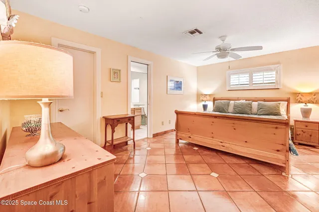 a bedroom with a bed and a ceiling fan