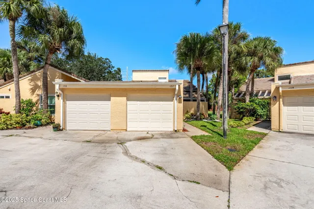 a view of a house with a yard and garage