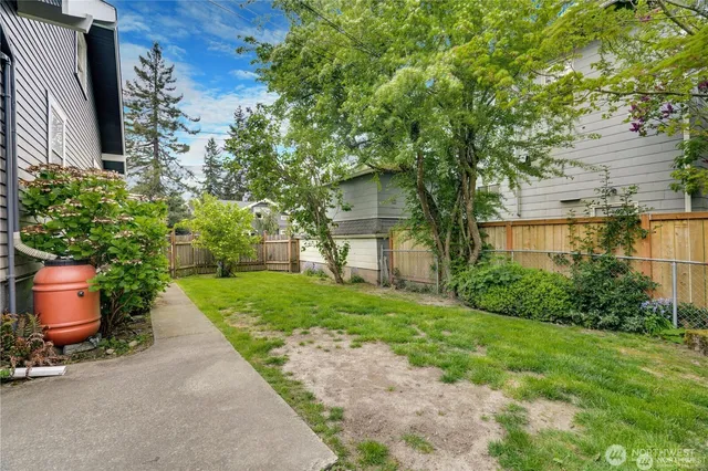 a front view of a house with a yard and tree s