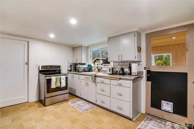 a kitchen with sink and cabinets