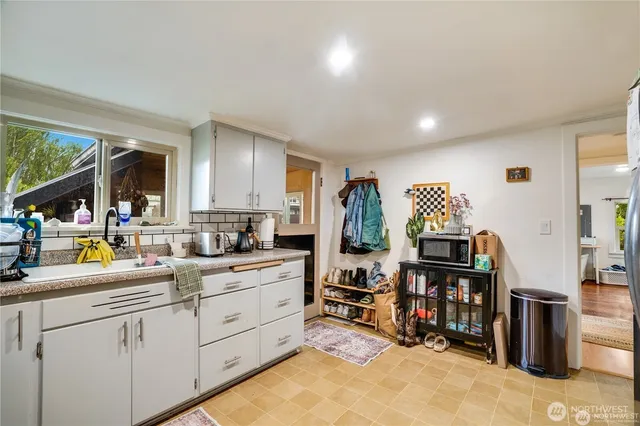 a kitchen that has a lot of cabinets a sink and a stove in it