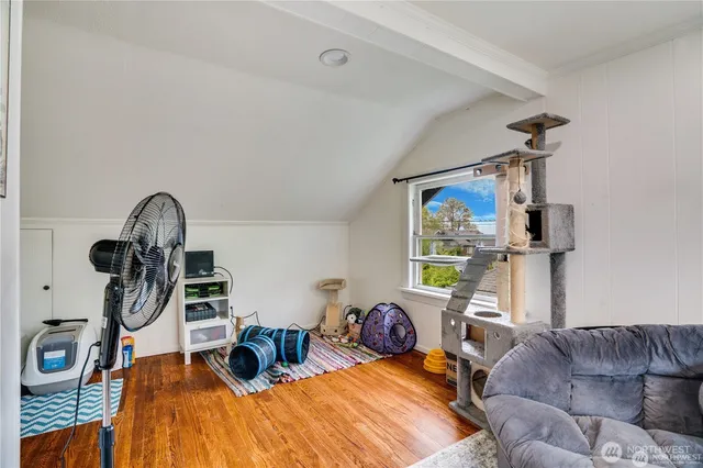 a living room with furniture a window and gym equipment
