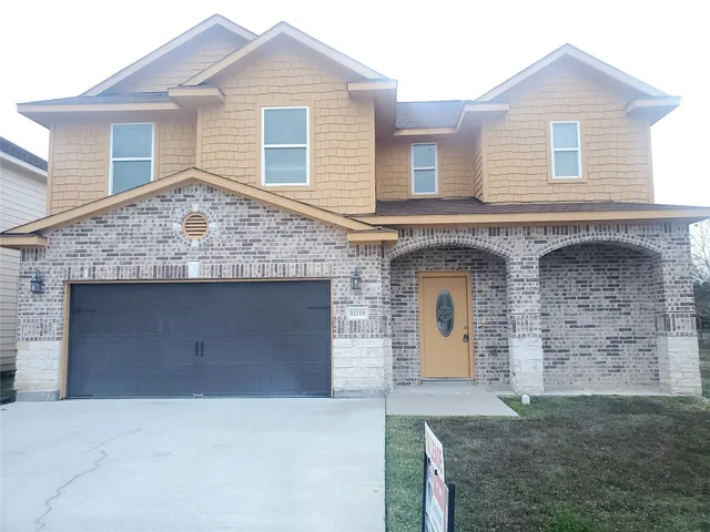 front view of a house with a brick wall