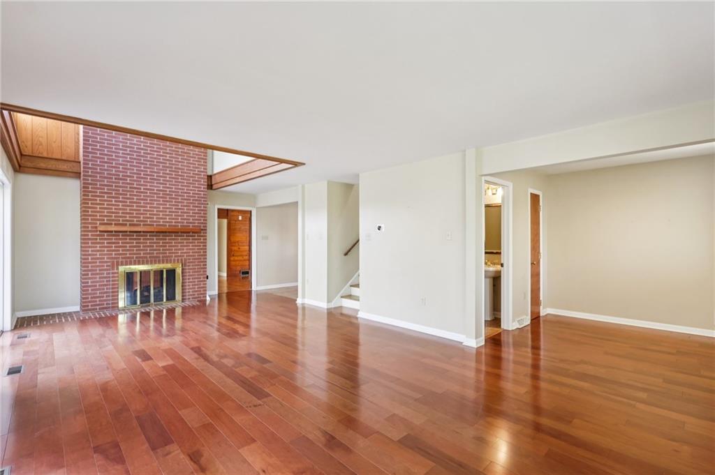 4561 School Road South Export, PA 15632 - Photo 13 of 48 a view of empty room with wooden floor and fireplace