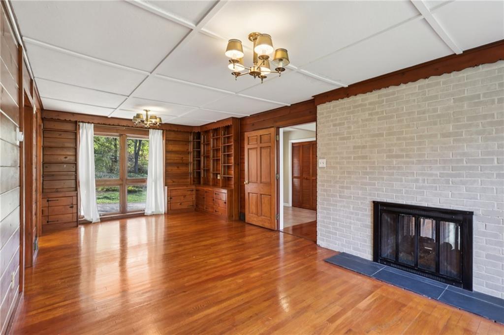 4561 School Road South Export, PA 15632 - Photo 17 of 48 a view of an empty room with wooden floor fireplace and a window
