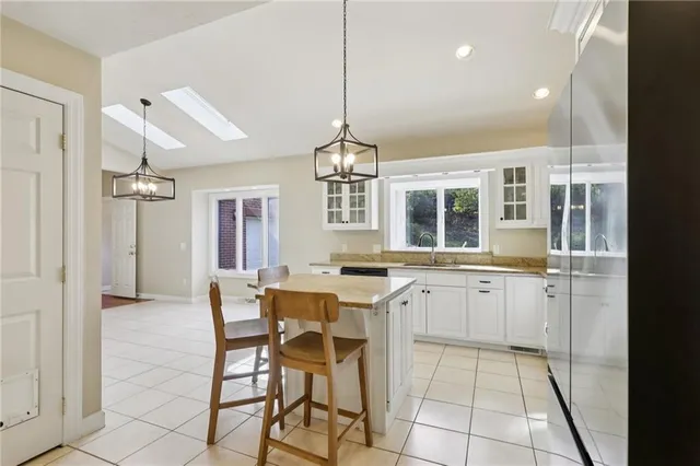 a kitchen with a sink a counter cabinets and appliances