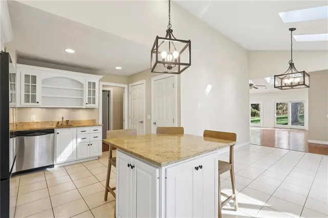 a kitchen with stainless steel appliances granite countertop a sink and cabinets