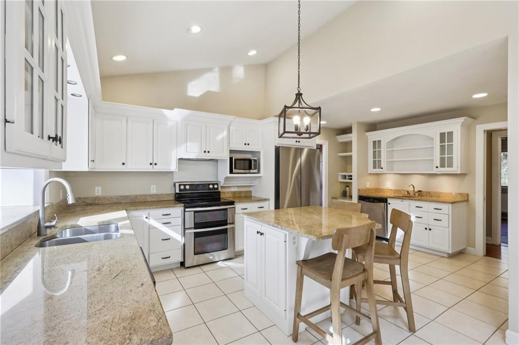 4561 School Road South Export, PA 15632 - Photo 24 of 48 a kitchen with stainless steel appliances granite countertop a stove a sink a oven a refrigerator a stove a kitchen island and chairs