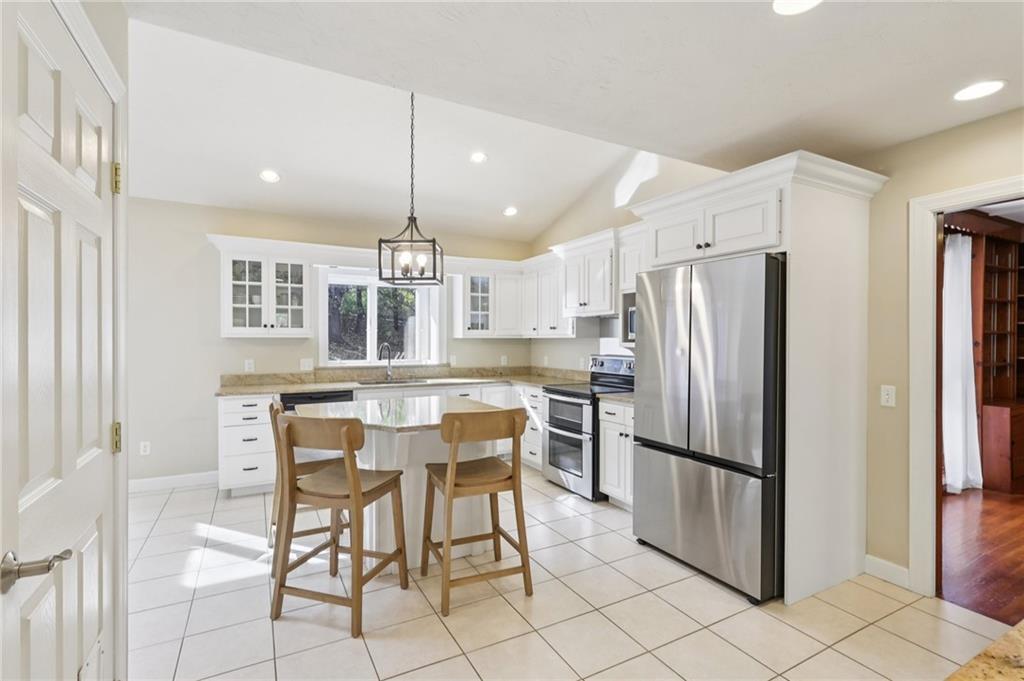 4561 School Road South Export, PA 15632 - Photo 25 of 48 a kitchen with stainless steel appliances kitchen island granite countertop a refrigerator and a stove top oven