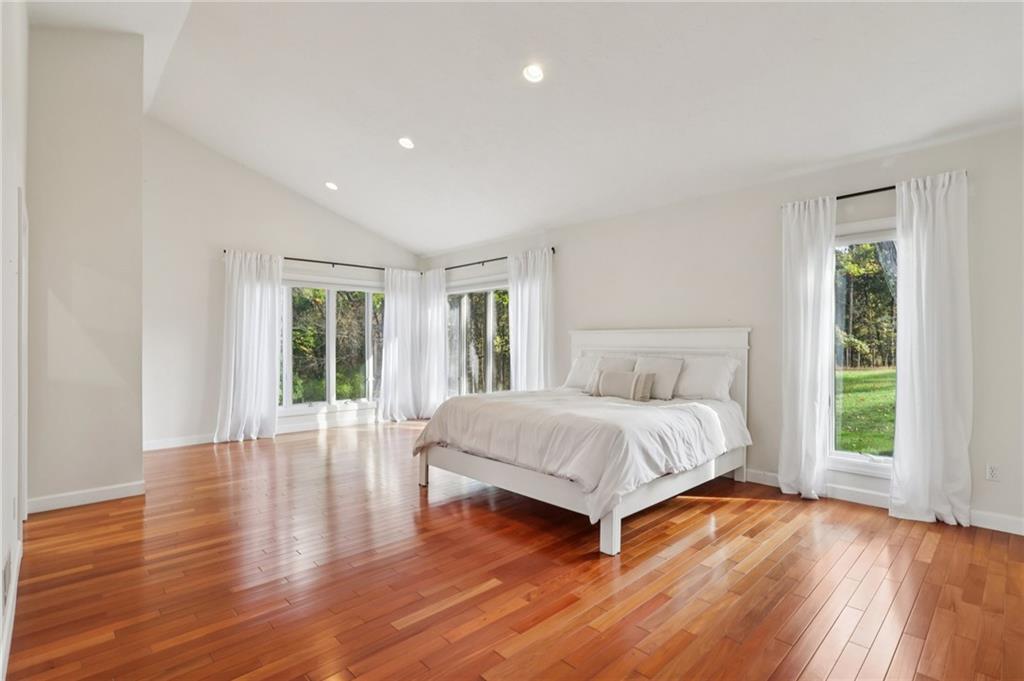 4561 School Road South Export, PA 15632 - Photo 28 of 48 a spacious bedroom with a large bed and wooden floor