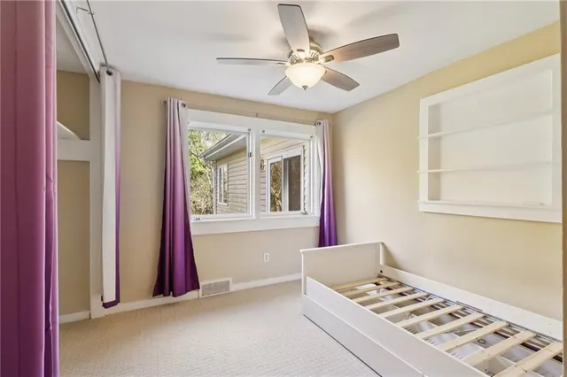 a very nice looking room with a window and a ceiling fan