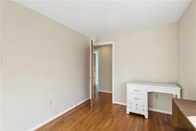 a room with wooden floor and furniture