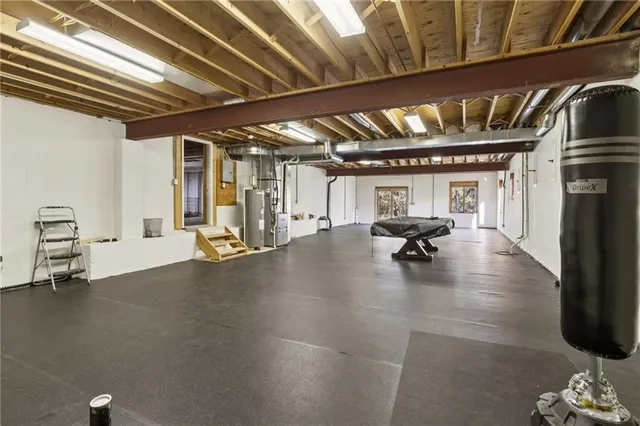 a gym with lots of furniture and chandelier