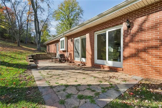 a view of a house with backyard porch and sitting area