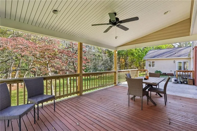 a view of a porch with furniture and a yard