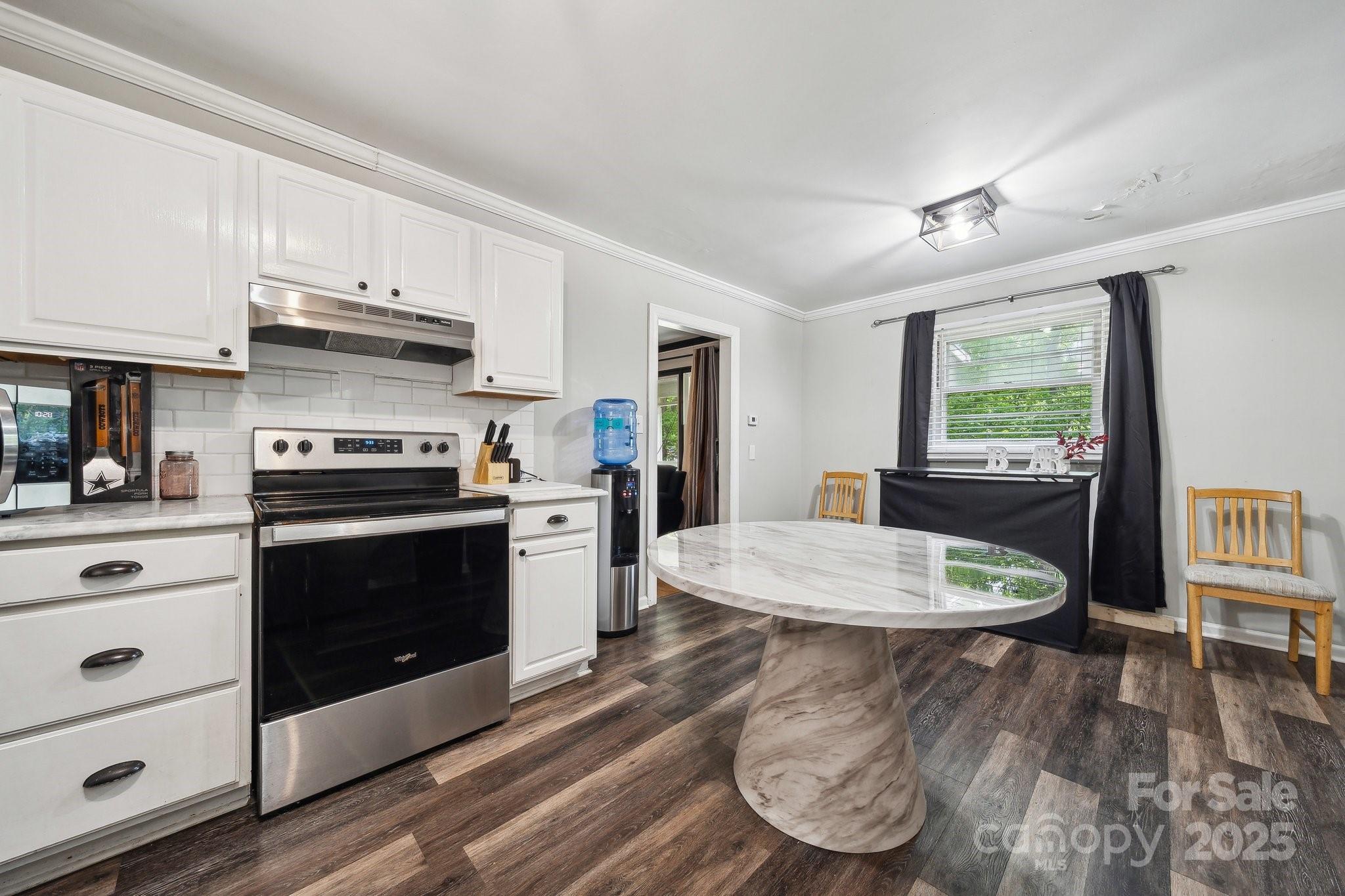 1917 Tom Sadler Road Charlotte, NC 28214 - Photo 11 of 27 a kitchen with a stove a refrigerator and a stove with wooden floor