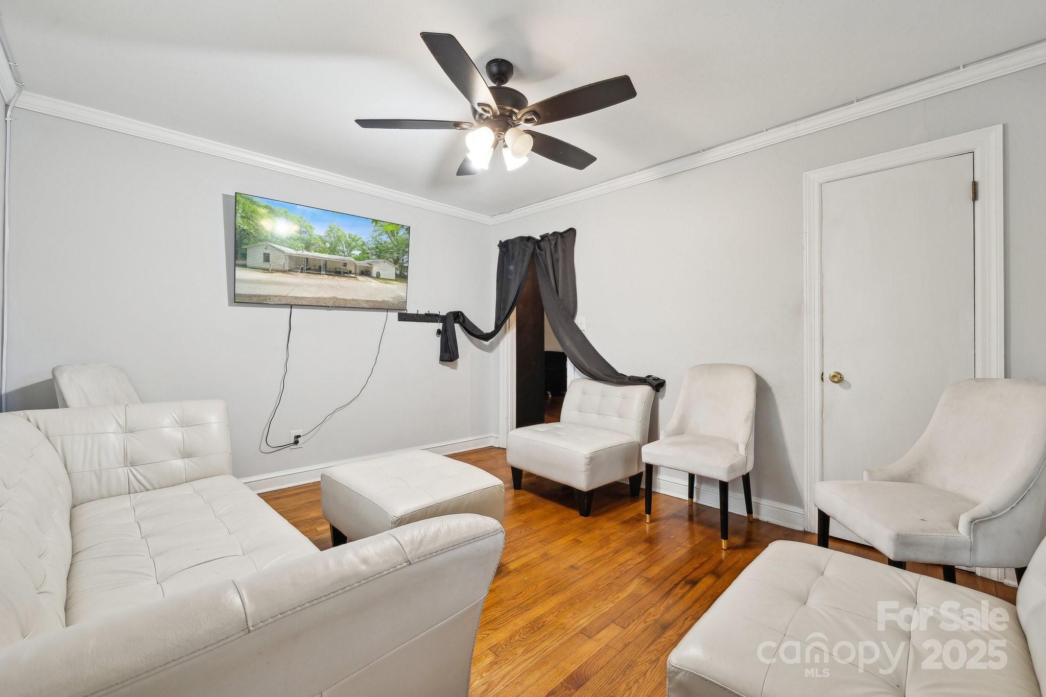 1917 Tom Sadler Road Charlotte, NC 28214 - Photo 19 of 27 a living room with furniture and a ceiling fan